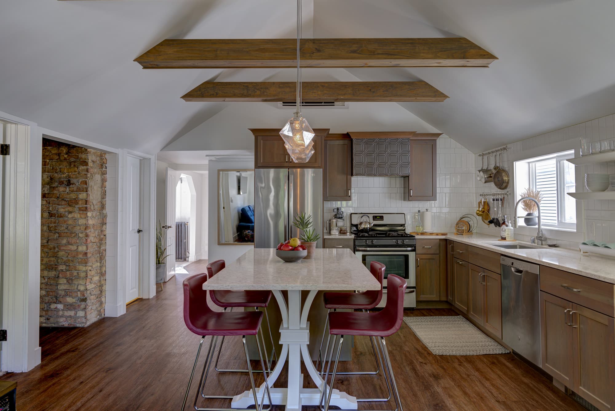 Kitchen island with pendant light and dining seating